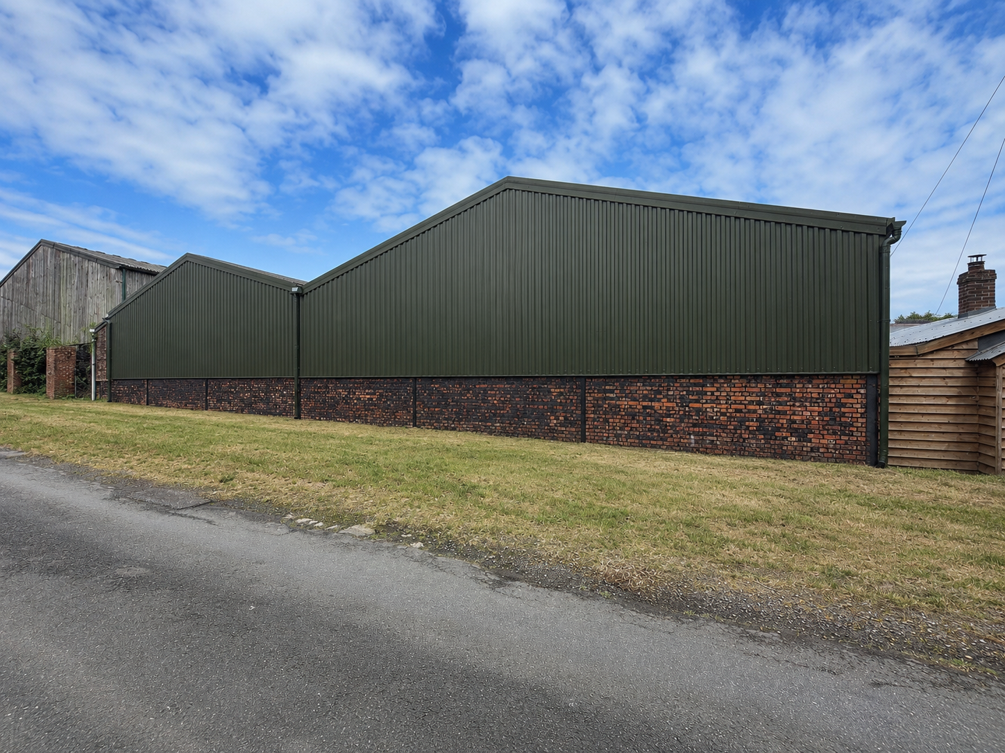 After barn recladding showing olive green box profile cladding